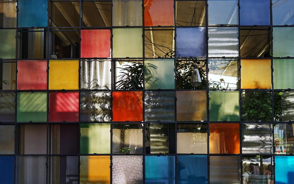 Looking through a wall of window panes, each with different color tints