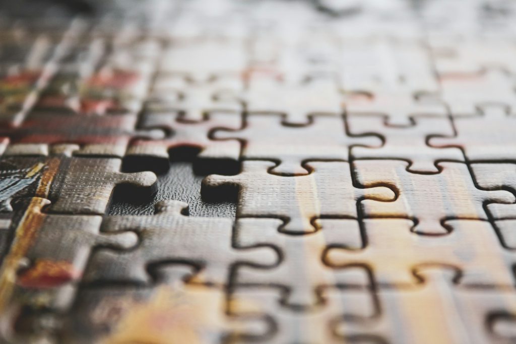 Photo of a puzzle close up with one piece missing